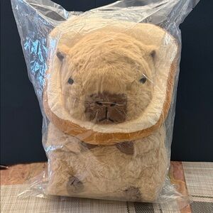 Capybara plush toy with a removable toast headpiece